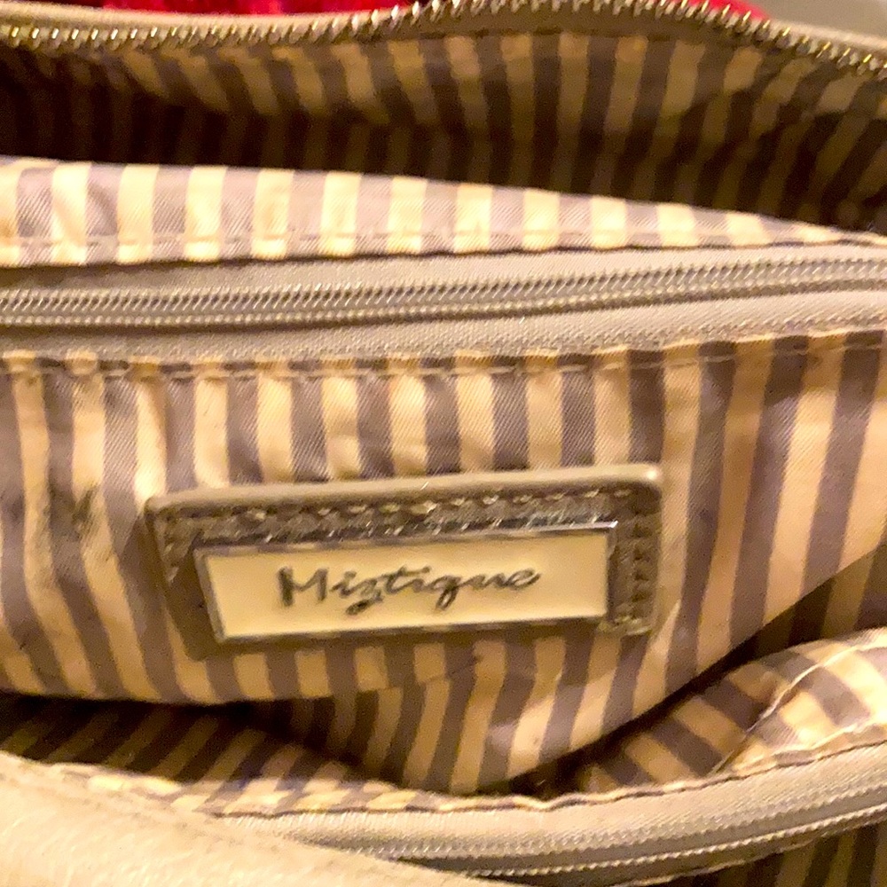 Backpack style taupe colored purse, striped inside